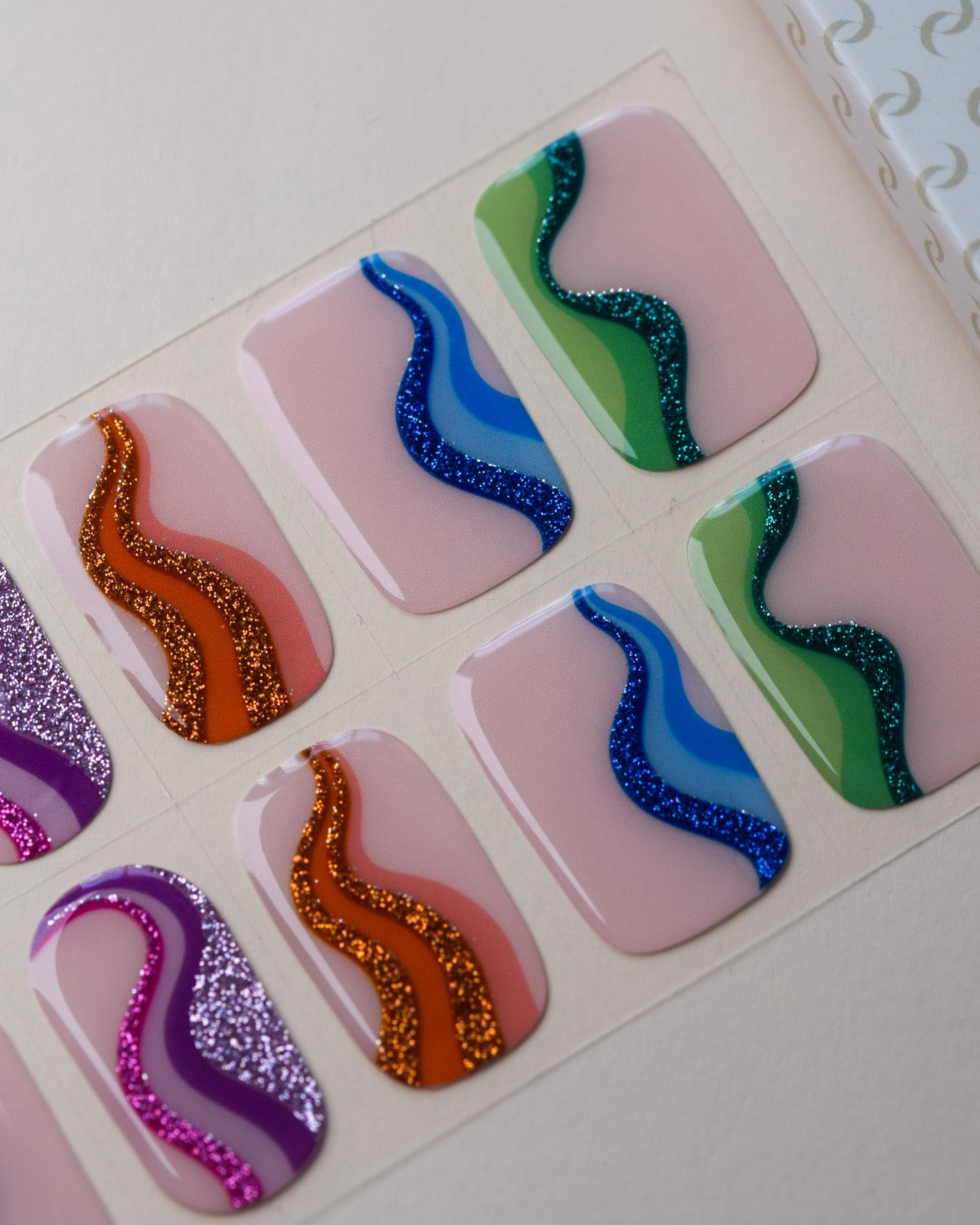 Mood Swing UV Gel Wraps auf dem Designbogen mit geschwungenen Linien in verschiedenen kräftigen Farben.