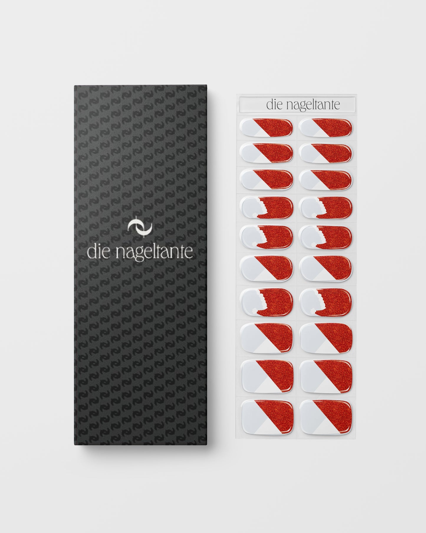 Detailaufnahme – funkelndes Rot mit feinen Glitzerpartikeln und weißen Weihnachtsmützen-Motiven.
