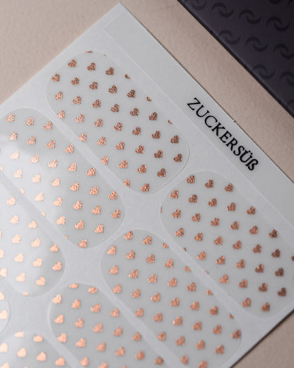 Zuckersüß Nailpolish Wraps als kompletter Folienbogen mit 20 selbstklebenden Nagelfolien in verschiedenen Größen.